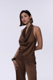 Woman wearing a brown jumpsuit on a white background